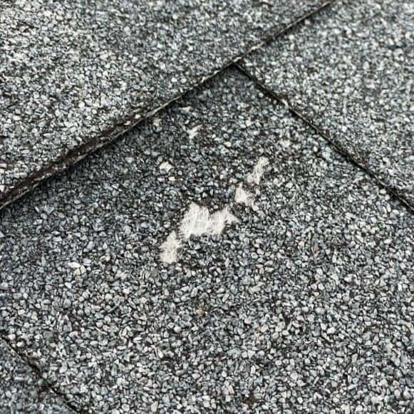 Split view of roof repair on one side and full roof replacement on the other on a residential home