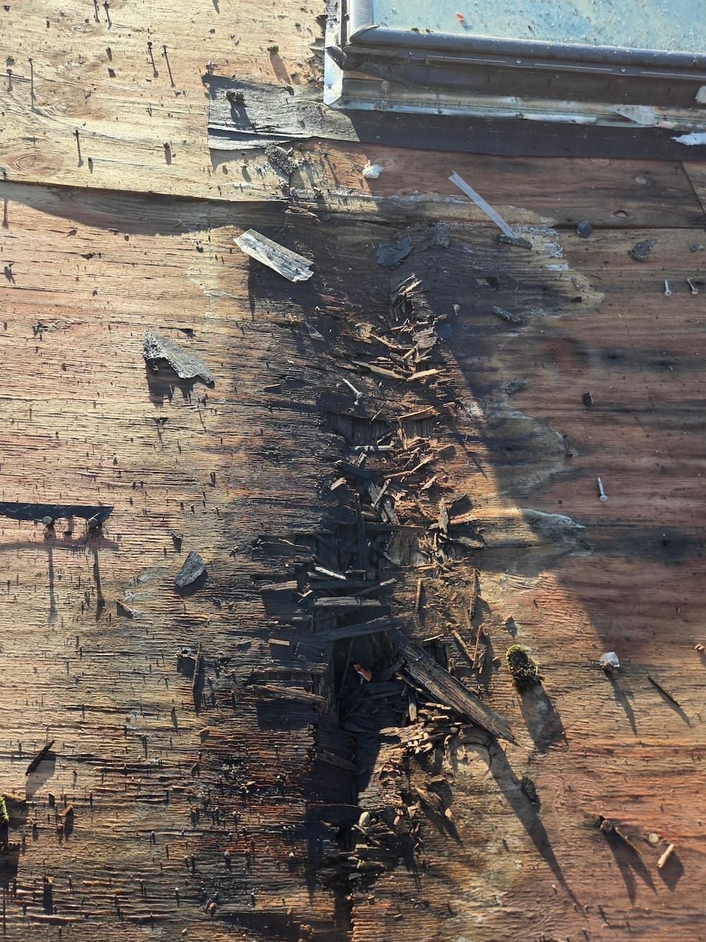 Roofer performing targeted repair work on a section of residential roof