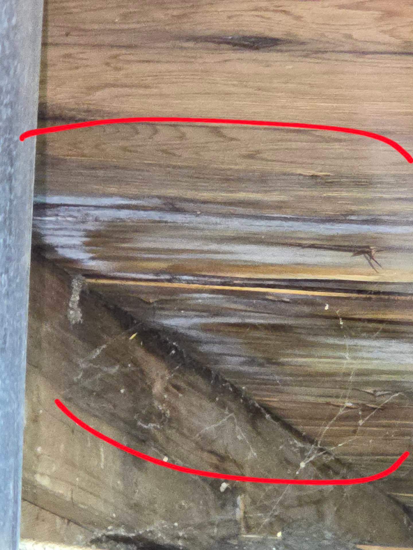 Real roof inspection finding: water-stained wood decking rot inside attic from poor ventilation on a Vancouver WA home
