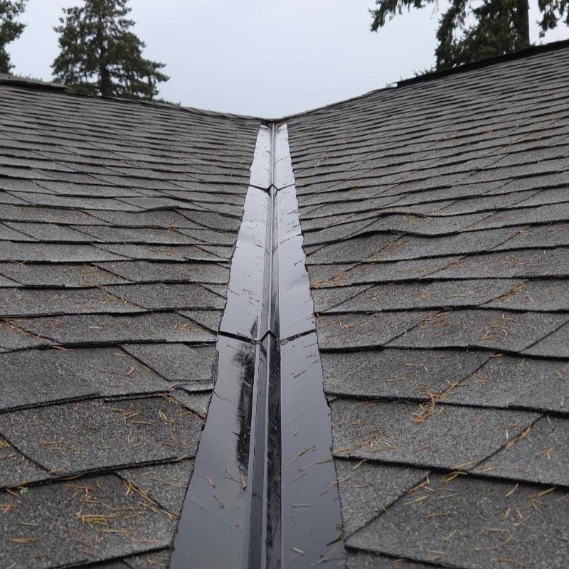 Warping and curling roof shingles near roof valleys