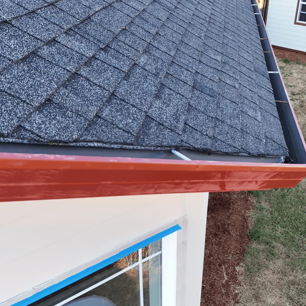 Custom red gutter installation by Gold Shield Exteriors